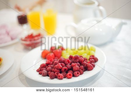 Bowl with berries on the table in kitchen