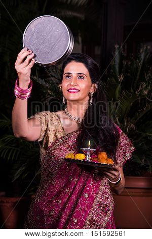 Karva Chauth puja and Hindu woman, indian young woman celebrating karwachauth festival
