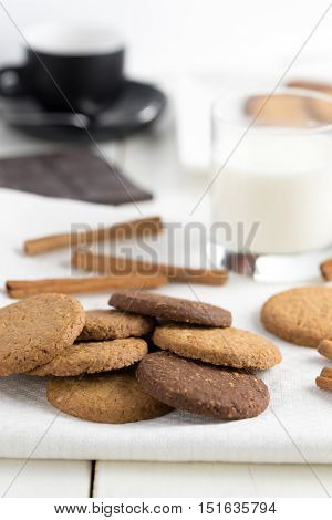 Biscuits on napkin with glass of milk.