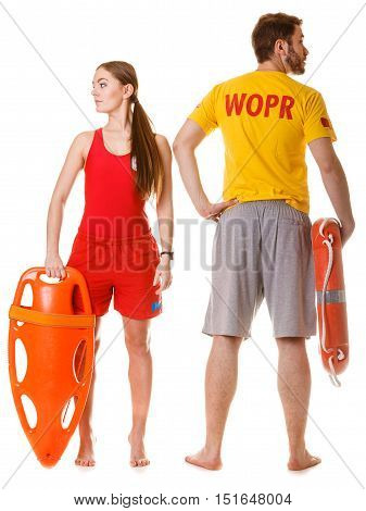 Lifeguards with rescue tube and ring buoy lifebuoy. Man and woman supervising swimming pool. Accident prevention.