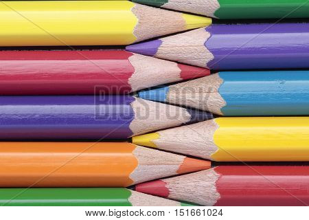 foreground of some crayons interleaved on a horizontal composition