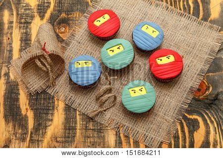 Delicious cupcakes with colored sugar mastic and decor