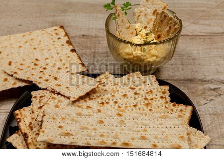 Cheese appetizer with garlic and matzo with fresh parsley leaves