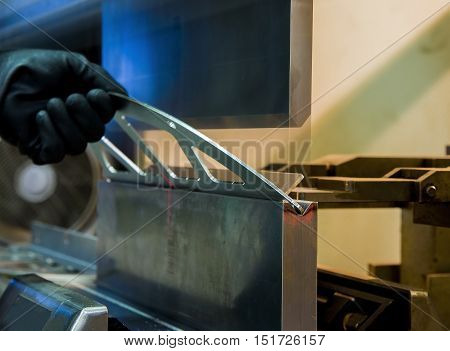 operator bending metal sheet by sheet bending machine