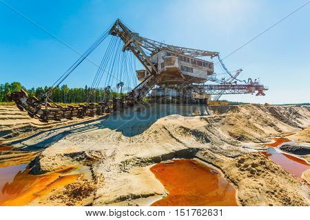 multi bucket excavator, giant stacker, absetzer in career. red water rich in minerals