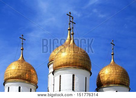 Golden onion domes of the fifteenth century orthodox temple in Moscow Kremlin