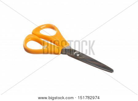 A pair of sissors in closed position with orange handles isolated on white background.