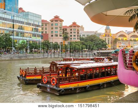 SINGAPORE, REPUBLIC OF SINGAPORE - JANUARY 10, 2014: Historical ships on the Singapore River. Clarke Quay Central disrict, Singapore