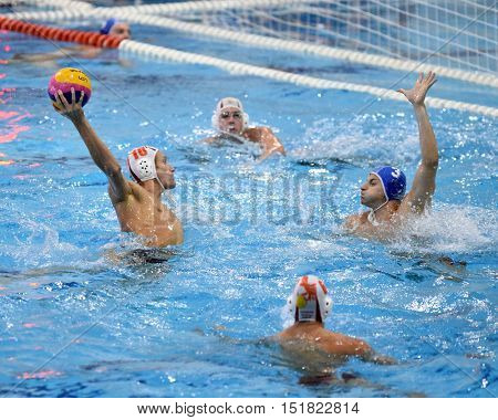 KAPOSVAR, HUNGARY - OCTOBER 5: Ferenc Windisch (white 10) in action at a Hungarian championship water-polo game between Kaposvar (white) and Honved (blue) on October 5, 2016 in Kaposvar, Hungary