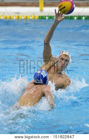 KAPOSVAR, HUNGARY - OCTOBER 5: Ferenc Windisch (in white) in action at a Hungarian championship water-polo game between Kaposvar (white) and Honved (blue) on October 5, 2016 in Kaposvar, Hungary
