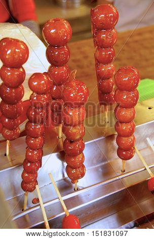 Sugar coated haws on a stick  closeup