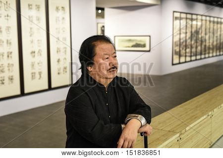 Saint-Petersburg Russia - September 12 2016: The richest Chinese artist Cui Ruzhuo to the opening of his exhibition in the Central Exhibition Hall on the background of his paintings.