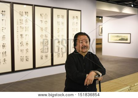 Saint-Petersburg Russia - September 12 2016: The richest Chinese artist Cui Ruzhuo to the opening of his exhibition in the Central Exhibition Hall on the background of his paintings.