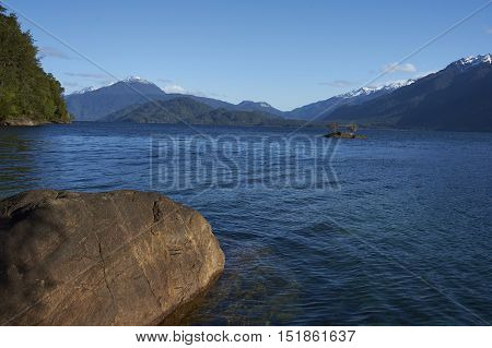 Lago Yelcho in the Aysen Region of southern Chile. Large body of fresh water surrounded by lush forest and snow capped mountains.