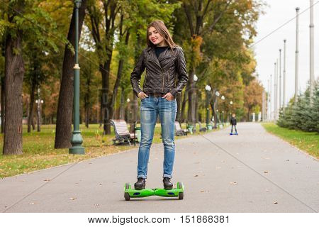 Young  Woman Riding Hoverboard - Electrical Scooter, Personal Eco Transport. On  Background Of  Boy