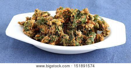 Palak pakoda, an Indian popular snack, made from deep frying portions of the batter of palak or spinach and chickpea flour.