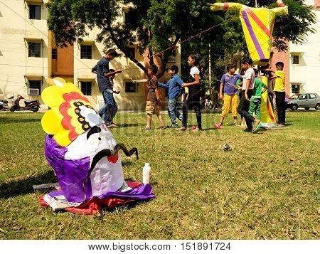 Delhi, India - 11th Oct: Children making a paper machie ravan effigy. Burning this effigy is part of the celebrations for the Hindu festival of Dussera which leads to Diwali
