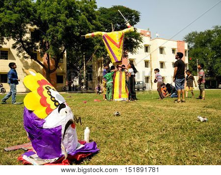 Delhi, India - 11th Oct: Children making a paper machie ravan effigy. Burning this effigy is part of the celebrations for the Hindu festival of Dussera which leads to Diwali