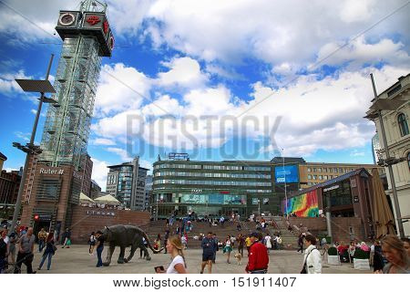OSLO NORWAY - AUGUST 18 2016: People walking on wonderful Plaza in front of Oslo Central station on nice sunny day in Oslo Norway on August 182016.