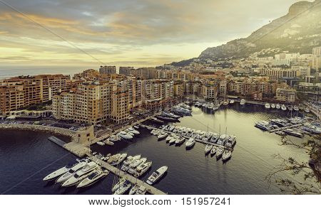 Panoramic view of Port de Fontvieille in Monaco. Azur coast. Colorful bay with a lot of luxury yachts in sunset.