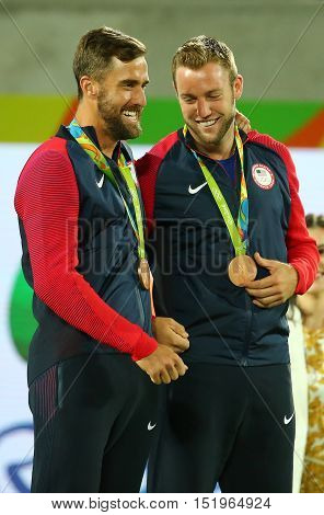 RIO DE JANEIRO, BRAZIL - AUGUST 12, 2016: Bronze medalists Steve Johnson (L) and Jack Sock of United States during medal ceremony after men's doubles final of the Rio 2016 Olympic Games