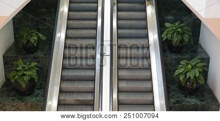 Two Escalators Side By Side In A Shopping Center