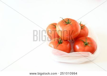 Freshness Top View Of Tomatoes Put In Plastic Bag On White Background And Vegetable Full With Nutrit