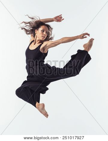 Beuatiful female dancer. Studio background.