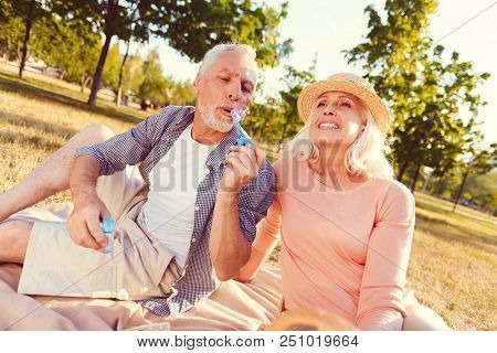 Back To Childhood. Low Angle Shot Of A Positive Minded Husband And Wife Recalling Their Memories And