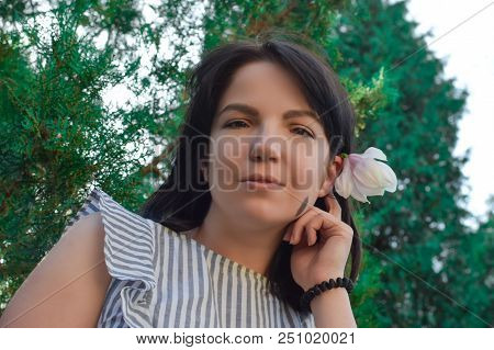 Beautiful Girl With Dark Hair And Different Eye Color Heterochromia . Smiles At The Photos In The Pa