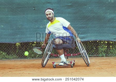Disabled Tennis Player Hits The Ball Forehand