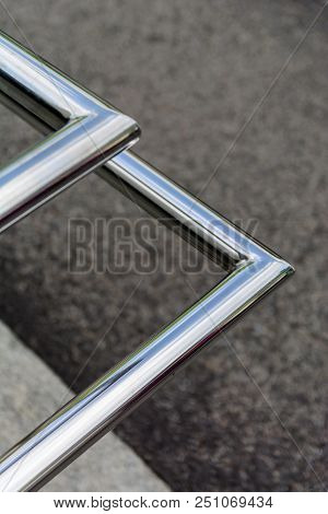 Polished Stainless Pipes Welded At An Angle. Gray Industrial Background. Diagonal.
