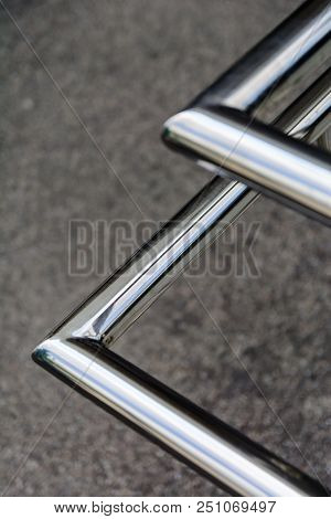 Polished Stainless Pipes Welded At An Angle. Gray Industrial Background. Diagonal.