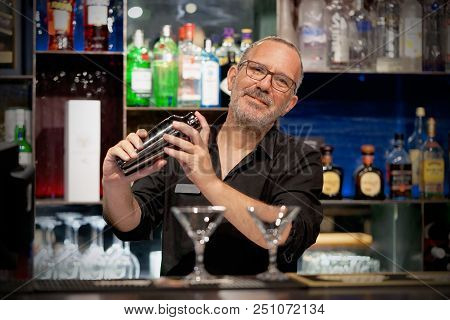 Professional Bartender Man Holding In Hands A Shaker With A Fresh Delicious Cocktail. Bartender Shak