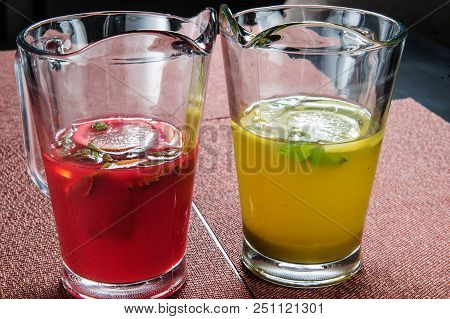 Yellow And Red Summer Lemonade Topped With Lemon.