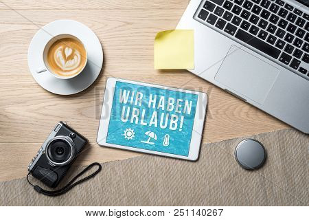 Wir Haben Urlaub Written In German On Tablet Meaning Company Holiday As Flatlay From Above Of An Off