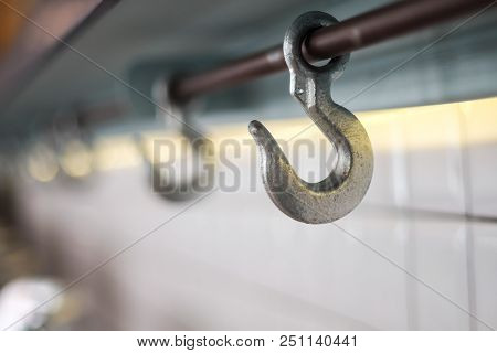 Row Of Cast Iron Hook For Hanging Bag Under The Counter Bar Top, Selective Focus.