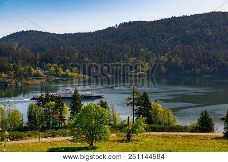 View of the shoreline of Salt Spring Island with ferry crusing the water, British Columbia, Canada