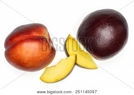 Group Of Two Whole Two Slices Of Ripe Deep Red Nectarine Flatlay Isolated On White