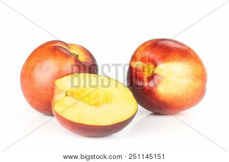 Group Of Two Whole One Half Of Ripe Deep Red Nectarine Isolated On White