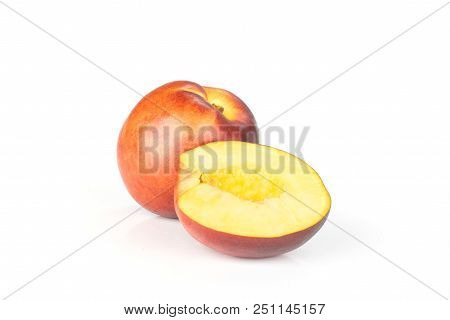 Group Of One Whole One Half Of Ripe Deep Red Nectarine Isolated On White