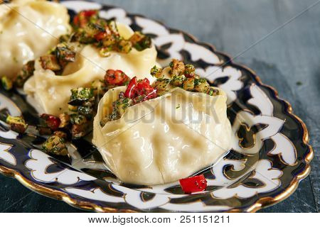 Manti, Mantu or Manty with Fried Vegetables and Spices Close Up. Vegan, Vegetarian Dumplings, Momos, Jiaozi, Dyushbara, Sikkim, Darjeeling, Ha Gao, Mandu, Manti, Pierogi, Xiao Long Bao Or Wontons