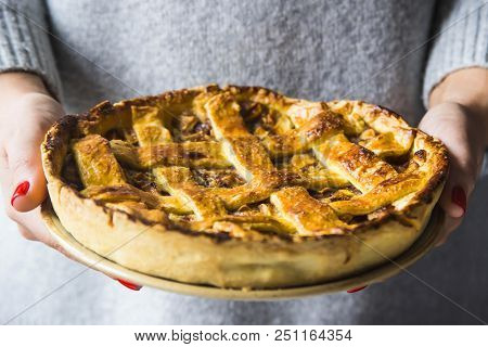 Homemade Apple Pie Sprinkled With Powdered Sugar With A Sliced Piece  Among Apples, Cinnamon Sticks 