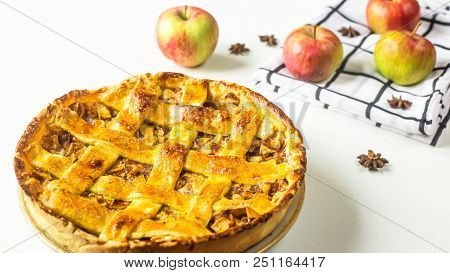 Traditional American Apple Pie With Dough Decoration In A Grid On A White Table. Autumn Baking Conce
