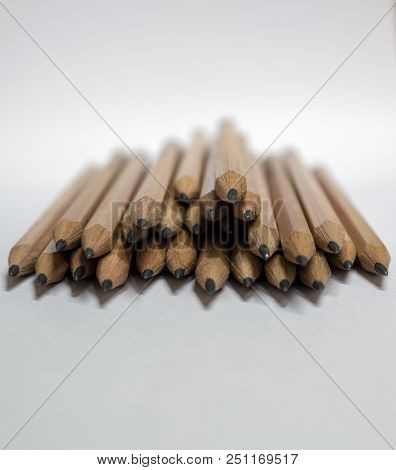 Many Brown Pencils Are Placed On Paper.