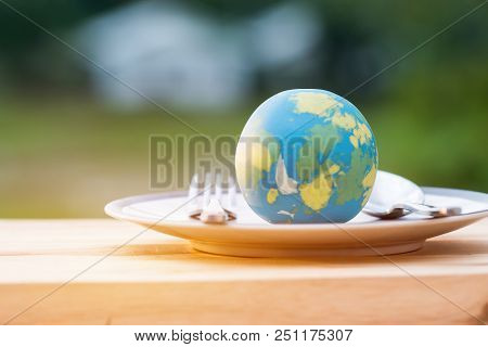 Globe Model Placed On Plate With Fork Spoon For Serve Menu In Famous Hotels. International Cuisine I