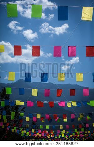 Colored Flags Against The Blue Mountains Small Scattered Flags Hung Over A Road In The Mountains, De