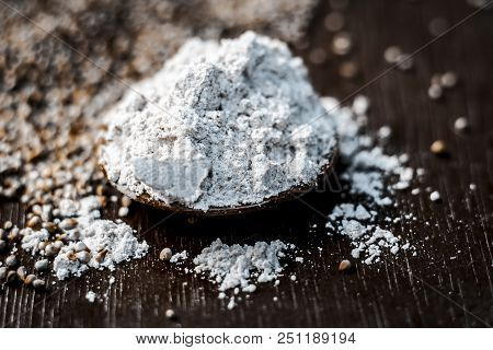 Close Up Of Flour Of Pearl Millet Or Bajra Ka Atta With Raw Pearl Millet On A Wooden Surface In Dark