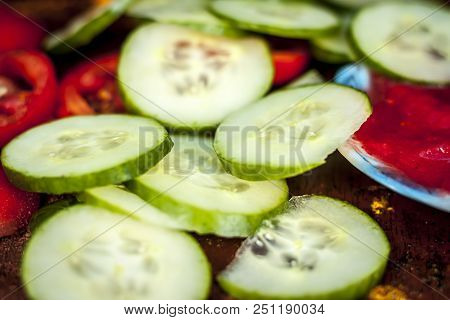 Close Up Ingredeints Of Ayurvdic Face Pack Of Vegetables I.e. Sliced Cucumber,tomato Puree,and Turme