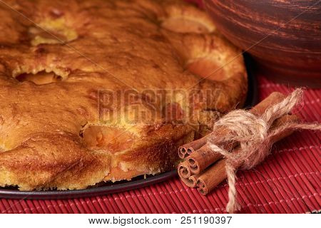 Apricot Pie And A Bowl With Flour And Other Ingredients On Wooden Table